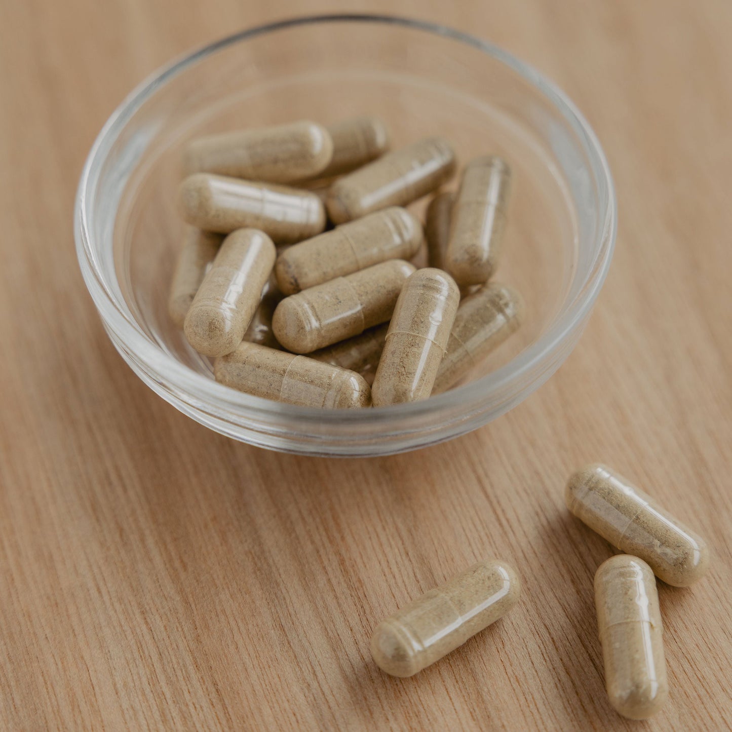 Close-up of Awaken Wellness Organic Beef Liver capsules in a glass bowl