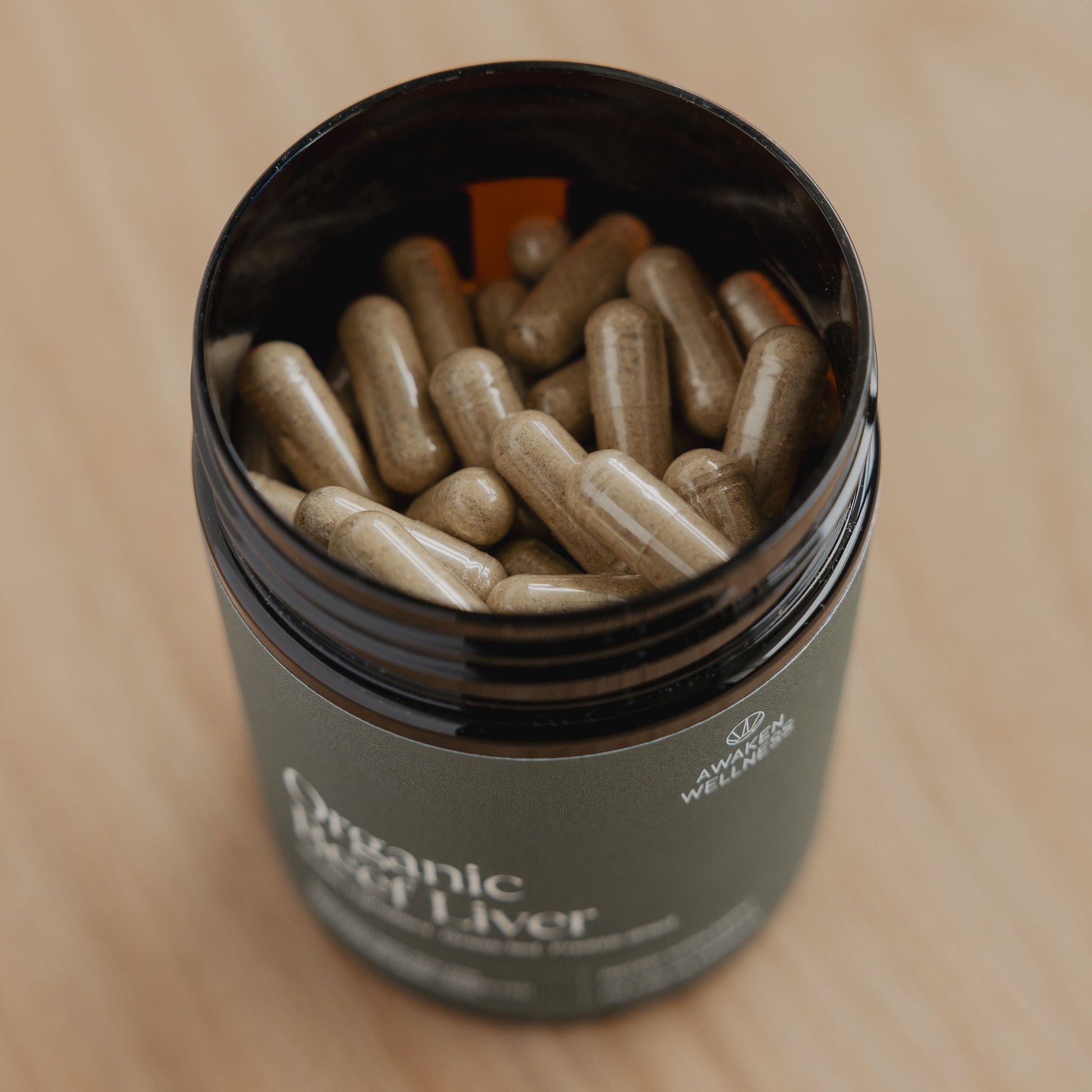 Awaken Wellness Organic Beef Liver bottle open, showing capsules inside